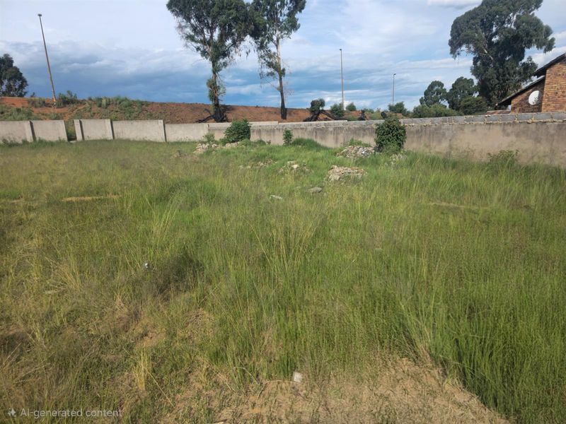 A vacant residential plot featuring perimeter boundary walls and overgrown grass, offering a blank canvas for future development.