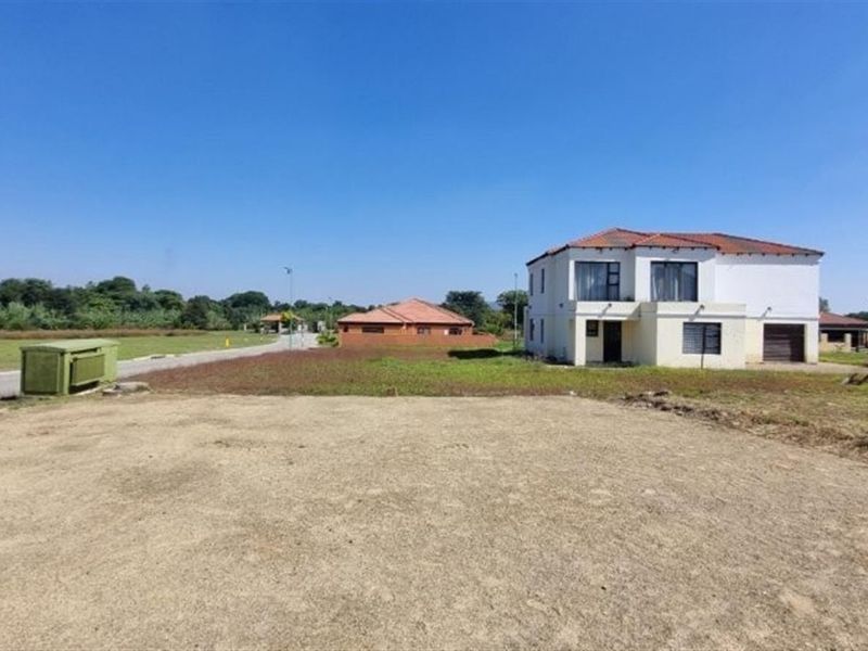 A vacant residential plot of land situated in a developed neighborhood with paved road access and surrounding residential properties.