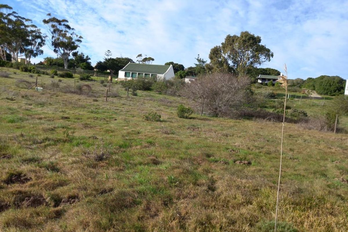 A wide-angle view of the farm property, showcasing the expansive natural landscape and the main dwelling nestled in the distance.