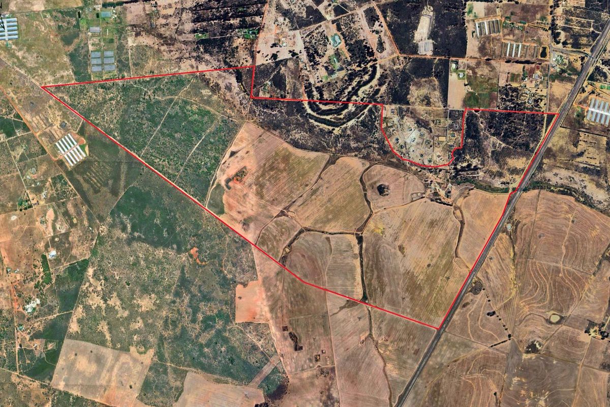 An aerial view showing the expansive boundaries and layout of the large agricultural farm property.