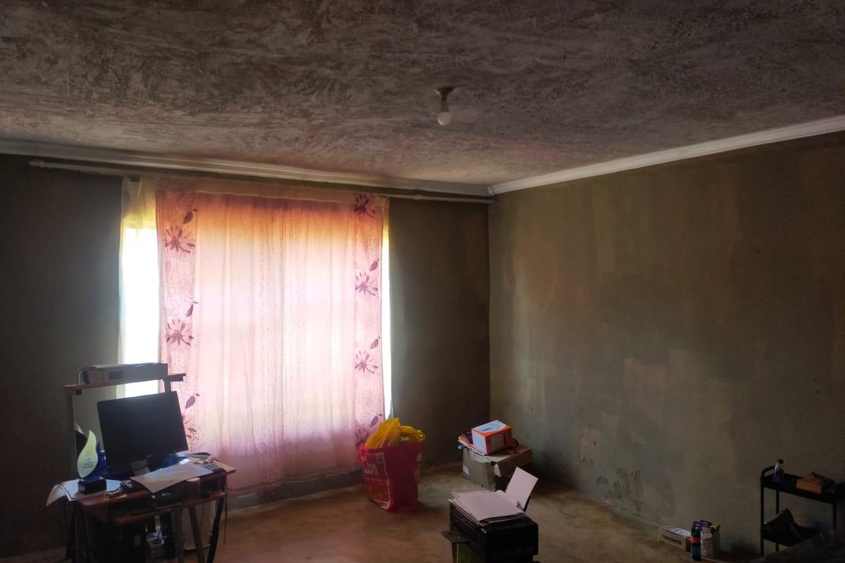 A bedroom space featuring textured ceilings and unfinished wall surfaces, offering a blank canvas for renovation and interior updates.