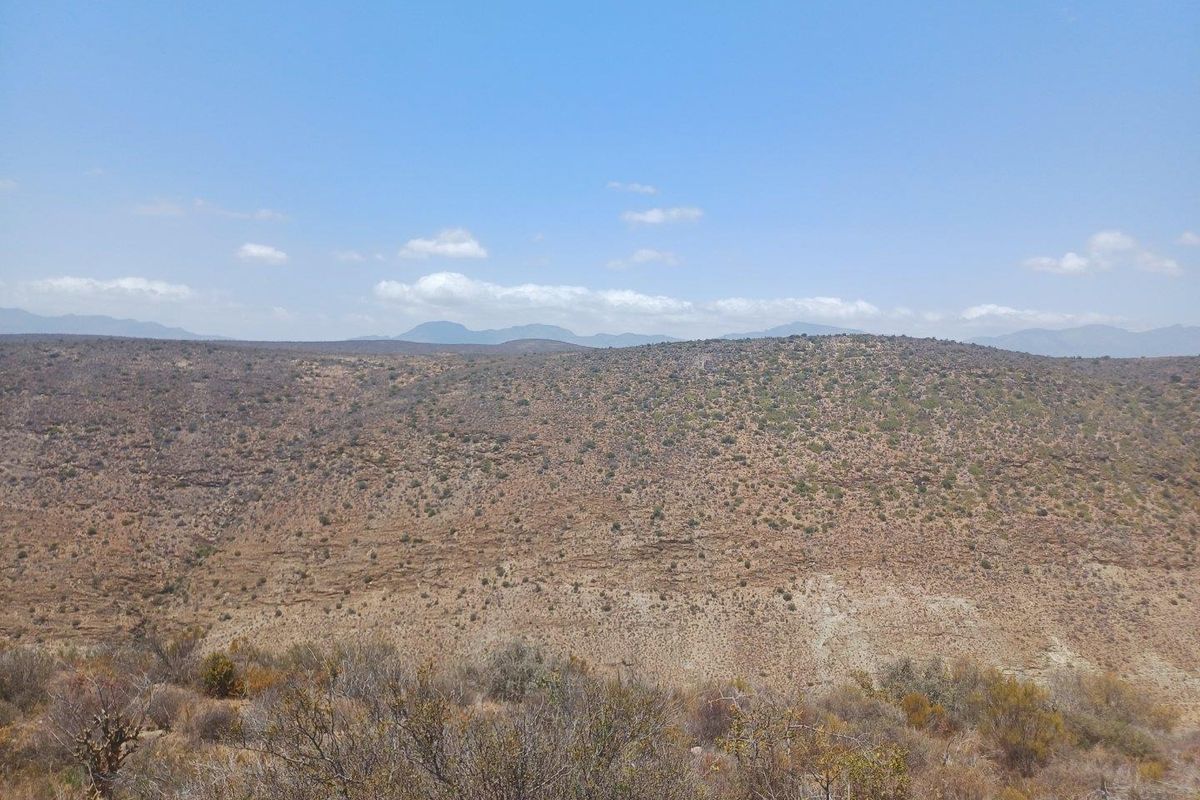 Expansive panoramic view of the surrounding arid landscape and distant mountain ranges.