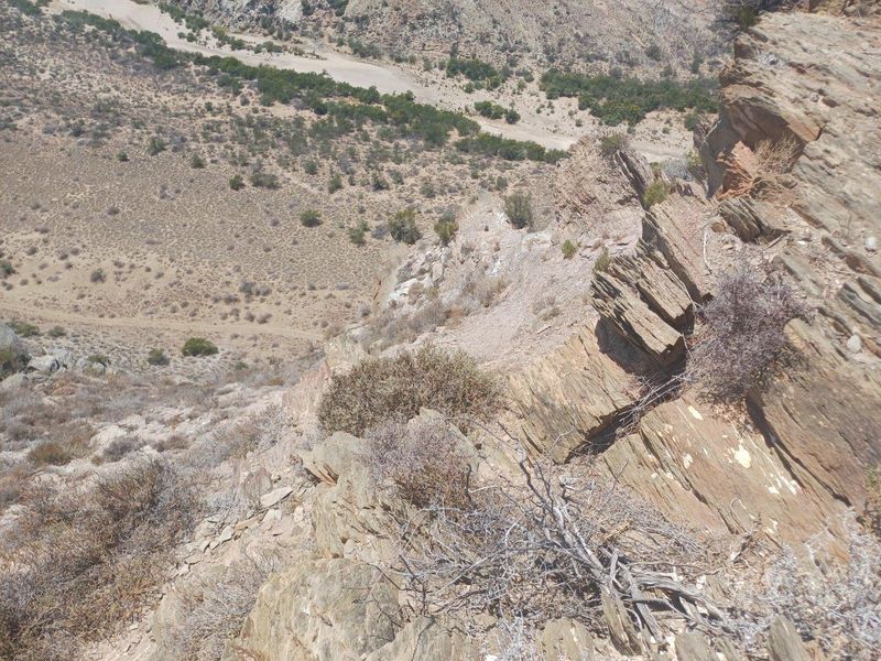 An elevated view overlooking the rugged, natural landscape and rocky terrain of the farm property.