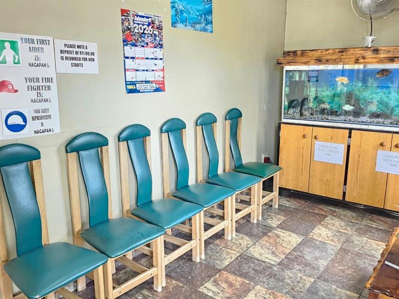 A waiting area featuring a built-in wooden cabinet with an integrated aquarium and tiled flooring.