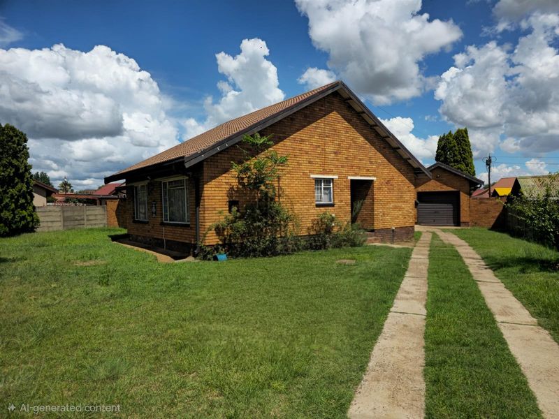 A detached brick house featuring a tiled roof, a concrete driveway, and a separate garage, set on a spacious grassed plot.