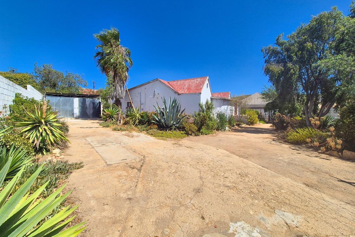 Versatile 4-Bedroom Home with Income-Generating Workshop in Uniondale - Photo 2