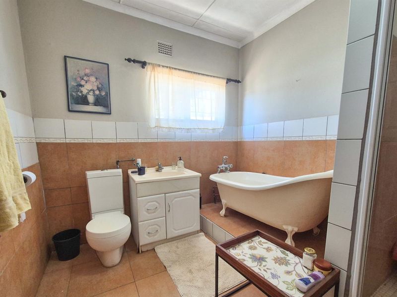 Versatile 4-Bedroom Home with Income-Generating Workshop in Uniondale - Photo 9