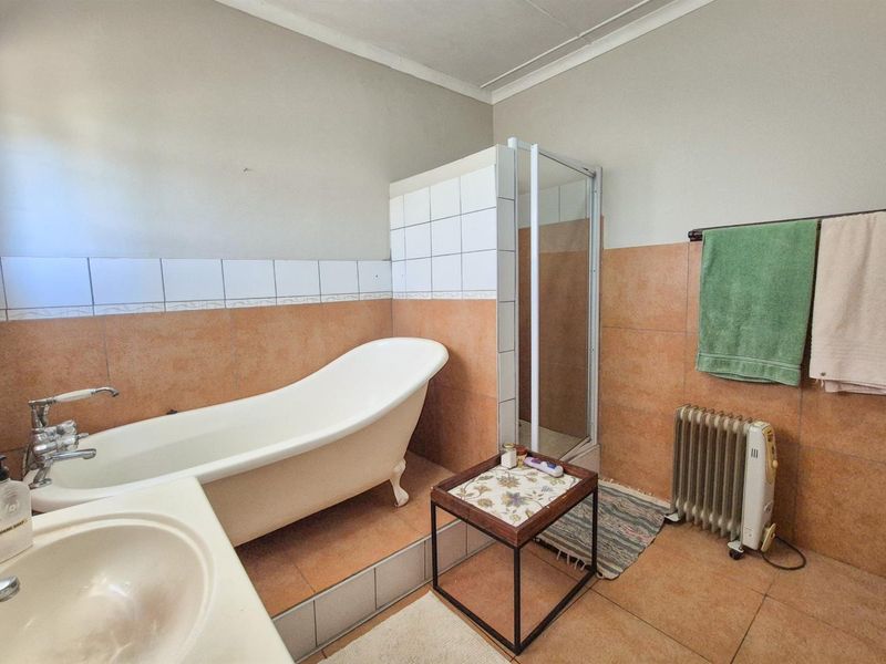 Versatile 4-Bedroom Home with Income-Generating Workshop in Uniondale - Photo 8