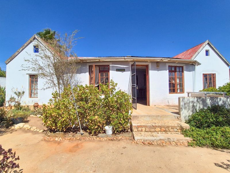 Versatile 4-Bedroom Home with Income-Generating Workshop in Uniondale - Photo 3