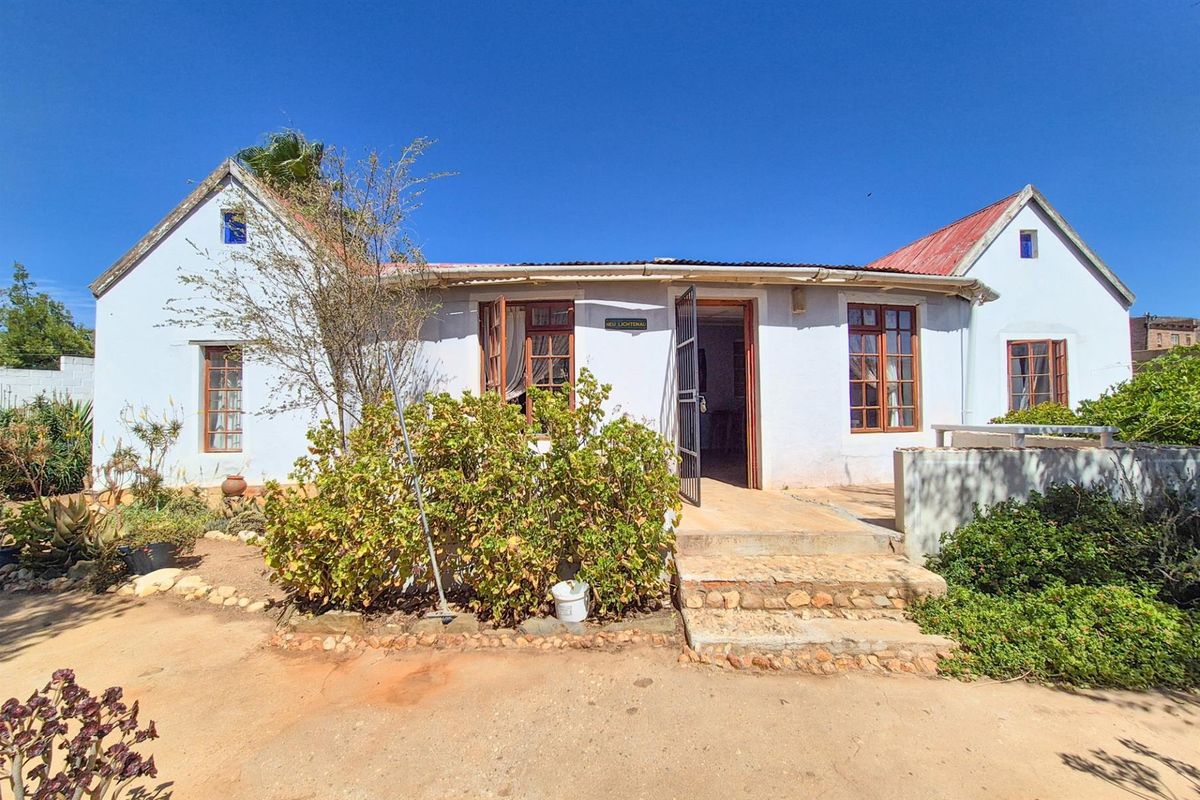 Versatile 4-Bedroom Home with Income-Generating Workshop in Uniondale - Photo 3