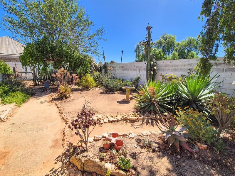 Versatile 4-Bedroom Home with Income-Generating Workshop in Uniondale - Photo 2