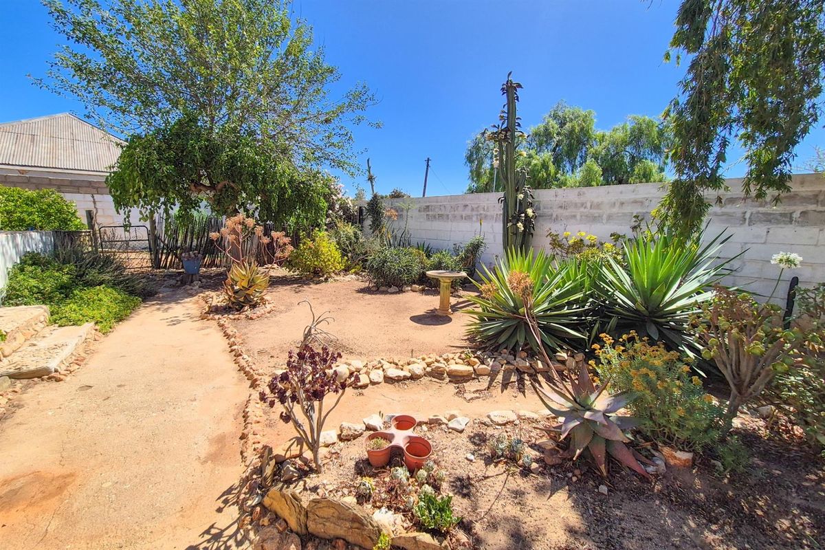 Versatile 4-Bedroom Home with Income-Generating Workshop in Uniondale - Photo 2