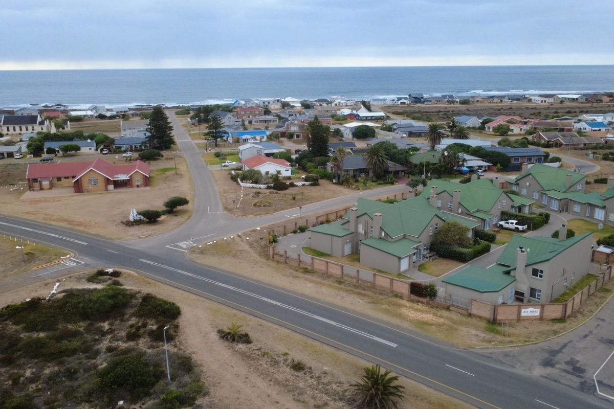Aerial view of the coastal townhouse complex, showcasing the property's location, surrounding neighbourhood, and proximity to the ocean.
