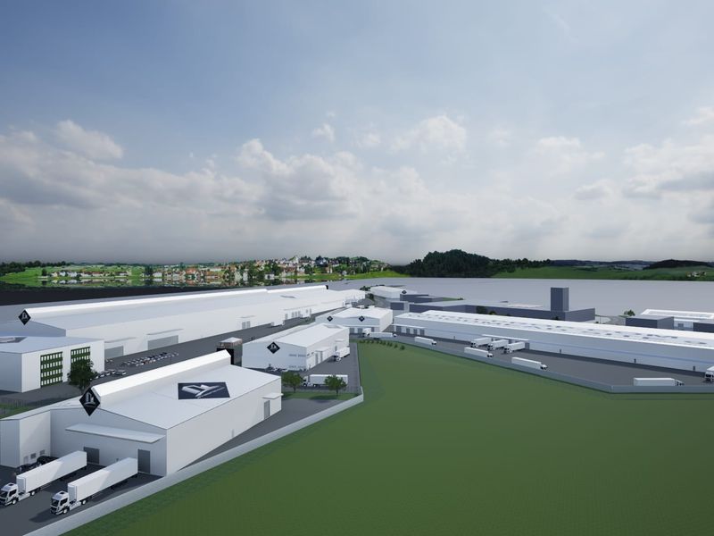 Aerial view of a large-scale industrial warehouse complex featuring multiple loading docks, extensive yard space, and secure perimeter fencing.