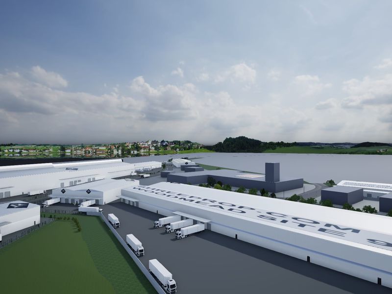 Aerial view of a large-scale industrial warehouse facility featuring extensive loading docks, paved yard space, and modern logistics infrastructure.