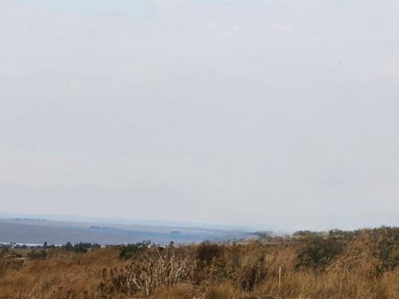A wide-angle view of the vacant residential land, showcasing the natural landscape and surrounding terrain.