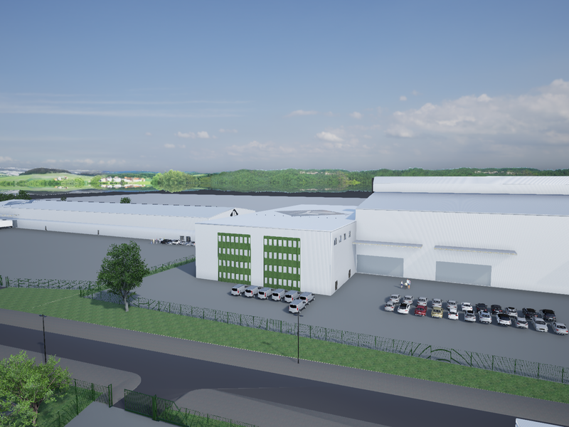 Aerial view of a large industrial warehouse facility featuring extensive parking, loading bays, and secure perimeter fencing.
