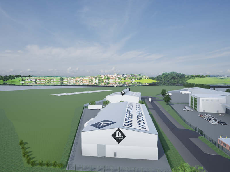 Aerial view of an industrial park featuring multiple warehouse facilities, paved access roads, and loading areas set within a landscaped site.