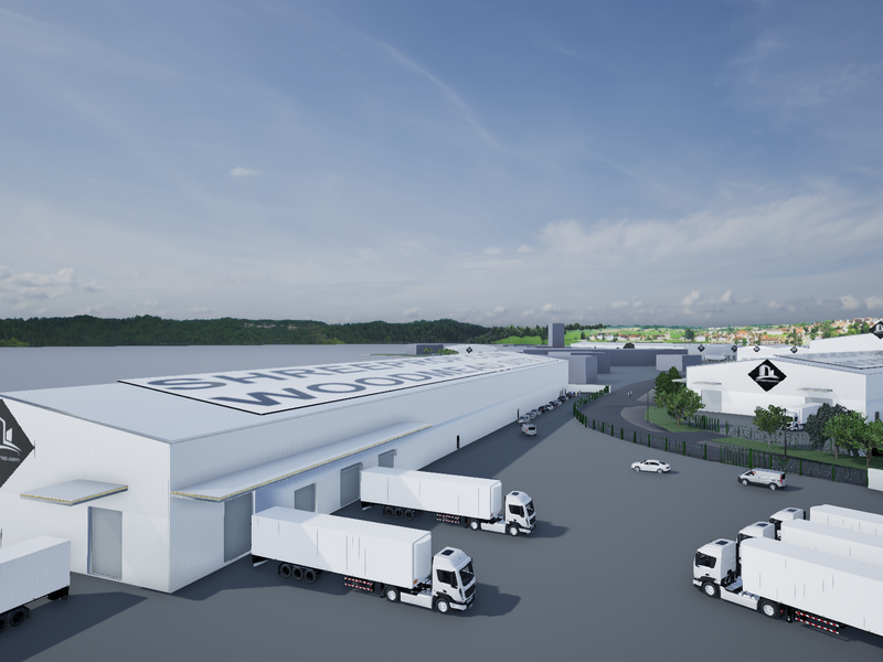 Aerial view of a modern industrial warehouse complex featuring extensive loading docks, paved yard space, and secure perimeter fencing.