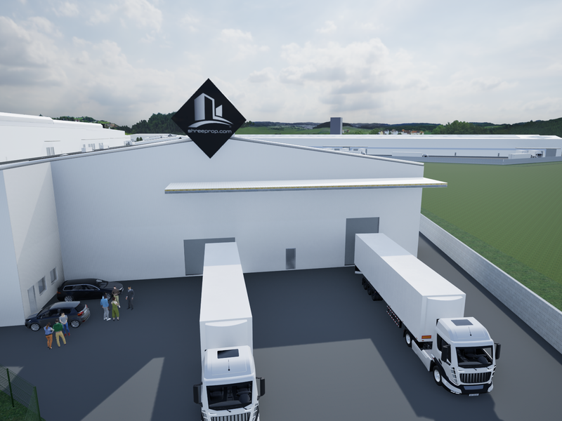 Aerial view of an industrial warehouse facility featuring loading bays, a paved yard, and perimeter fencing.