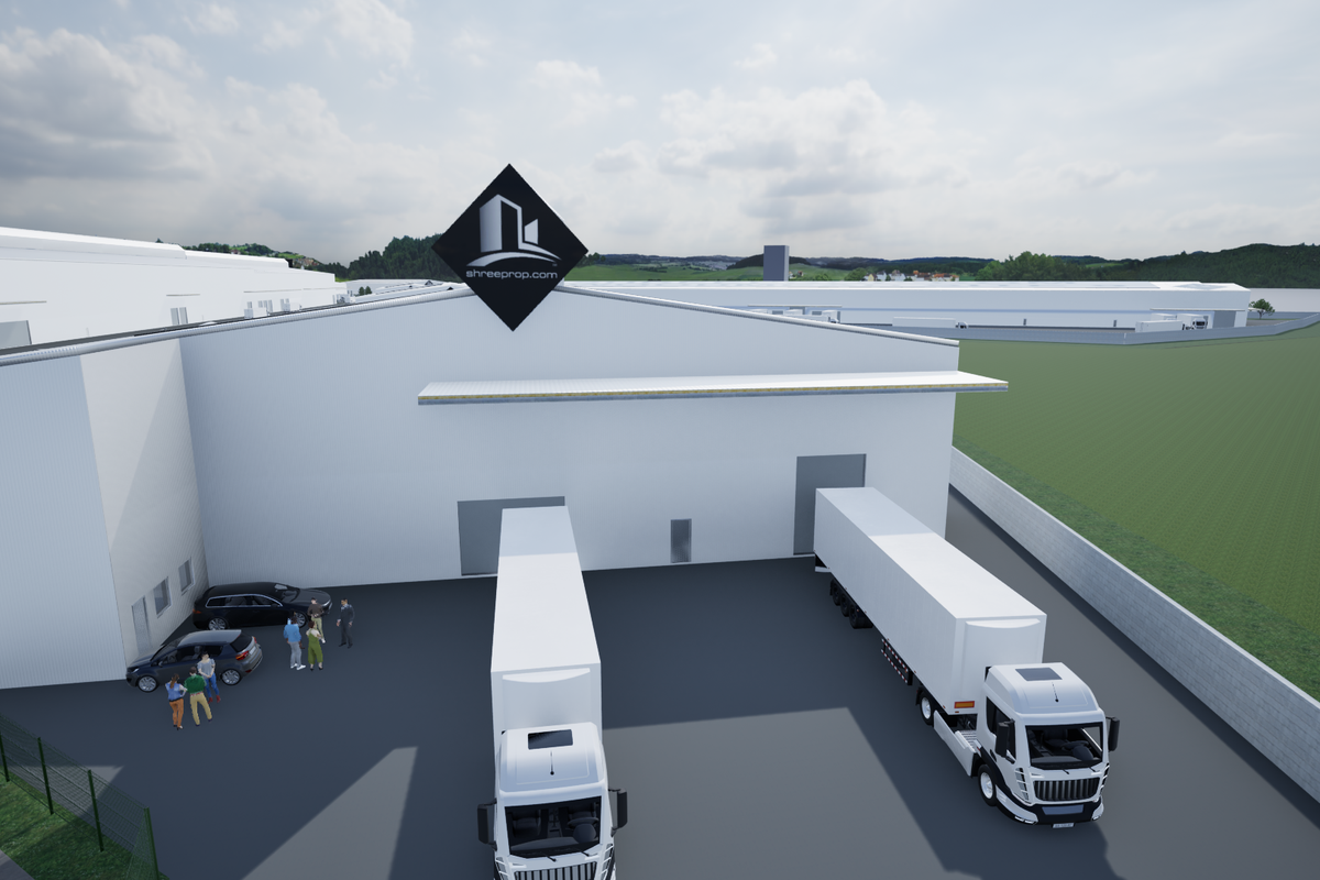 Aerial view of an industrial warehouse facility featuring loading bays, a paved yard, and perimeter fencing.