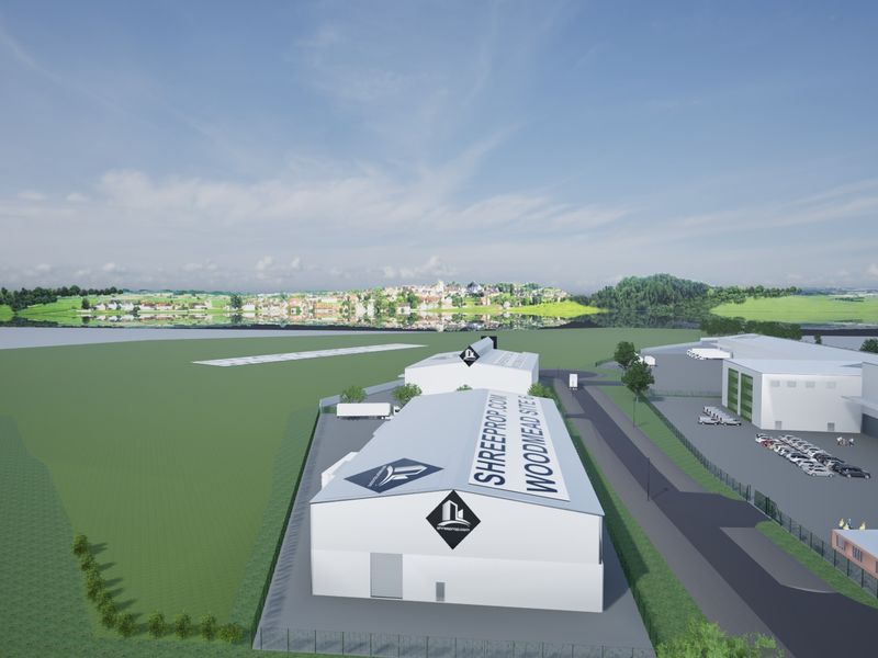 Aerial view of an industrial park featuring multiple warehouse buildings, access roads, and loading facilities in a landscaped setting.