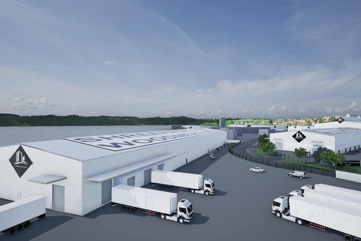 Aerial view of a modern industrial warehouse complex featuring extensive loading docks, paved yard space, and secure perimeter fencing.