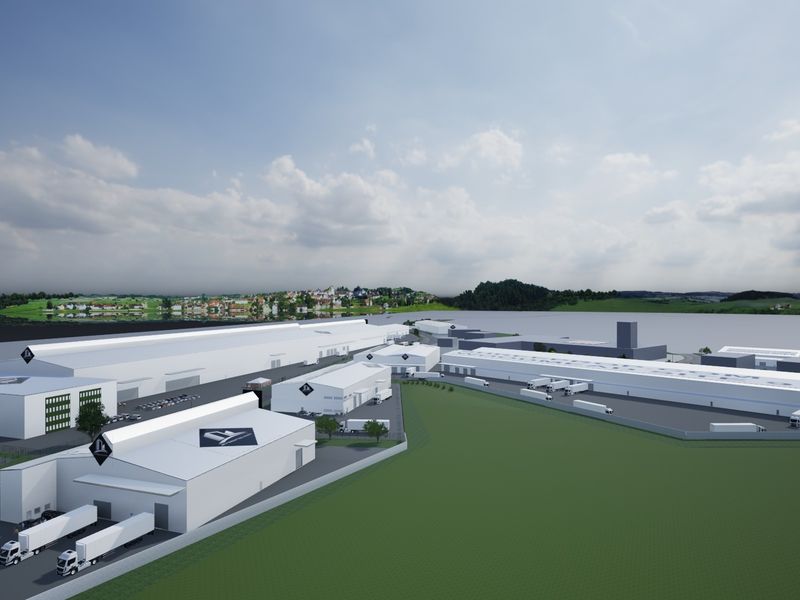 An aerial view of a large-scale industrial warehouse complex featuring multiple loading docks, extensive yard space, and secure perimeter fencing.