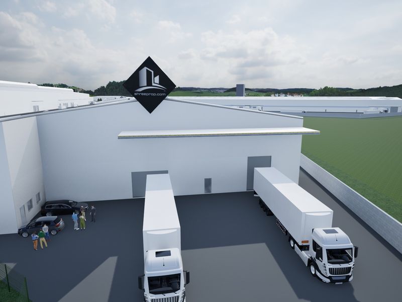 An aerial view of an industrial warehouse facility featuring a large asphalt yard, loading bays, and perimeter fencing.