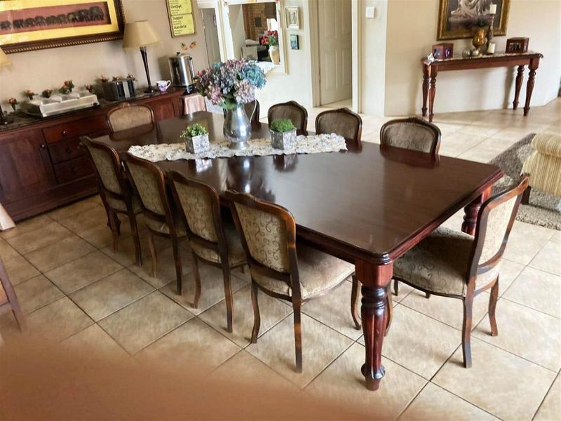 Spacious dining area featuring tiled flooring, providing a functional space for family meals and entertaining.
