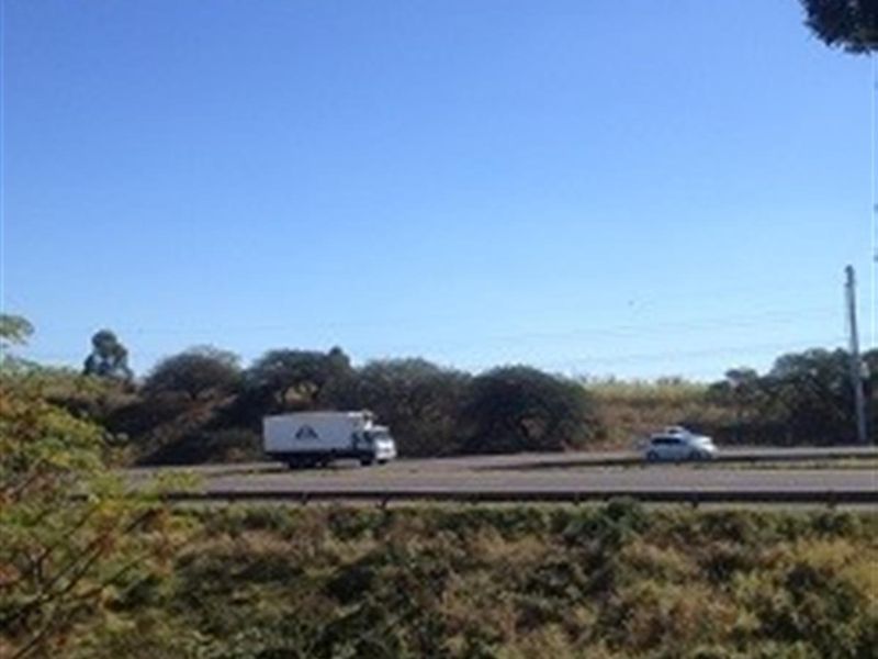 A view of the adjacent road and surrounding landscape, highlighting the property's proximity to transport infrastructure.