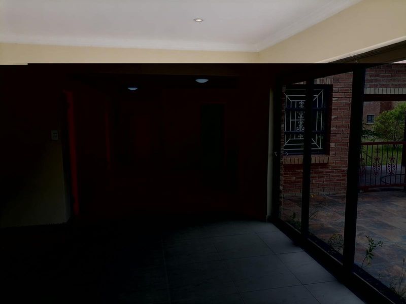 An interior living space featuring large sliding glass doors that provide access to an outdoor patio area.