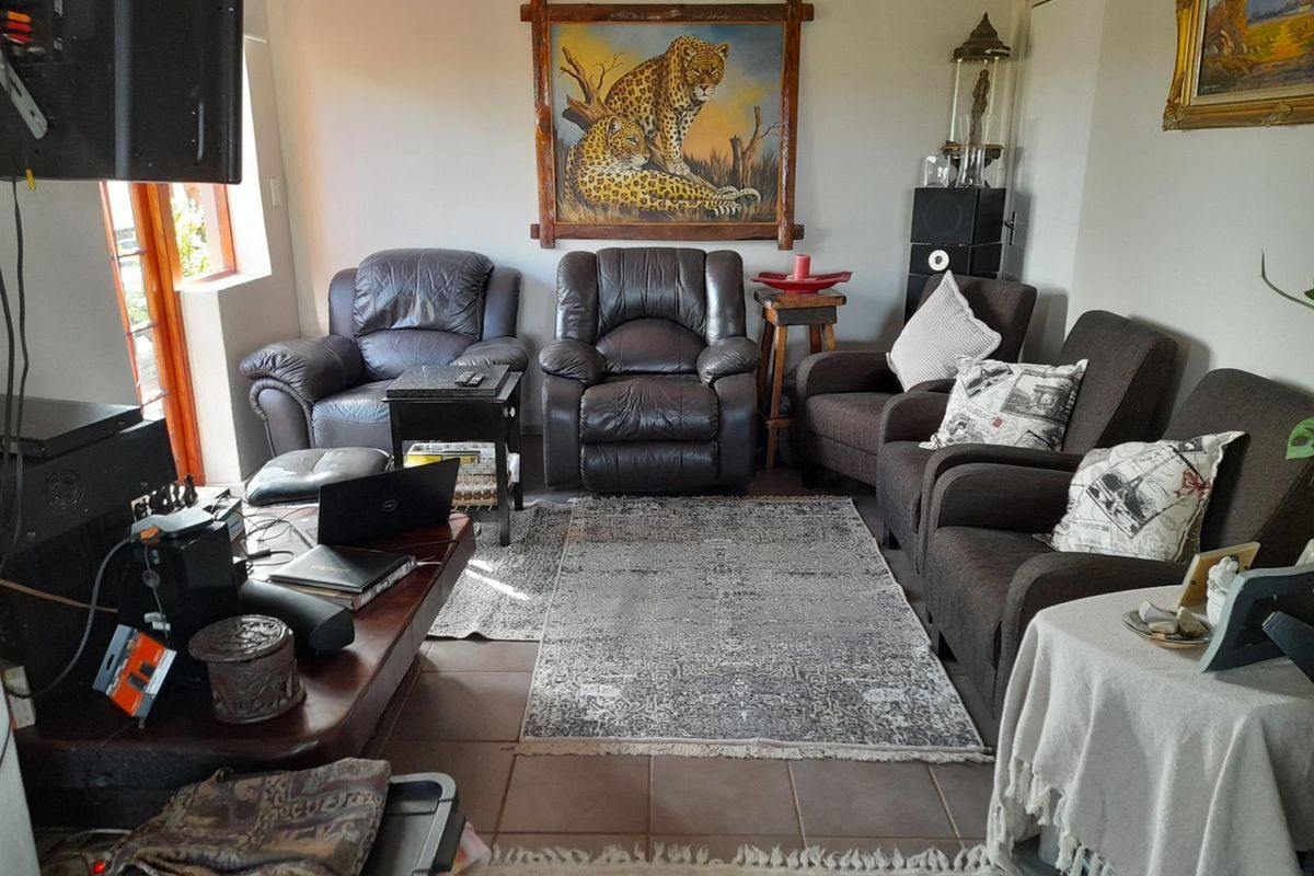 A comfortable living room area featuring tiled flooring and neutral wall finishes, providing a functional space for relaxation.