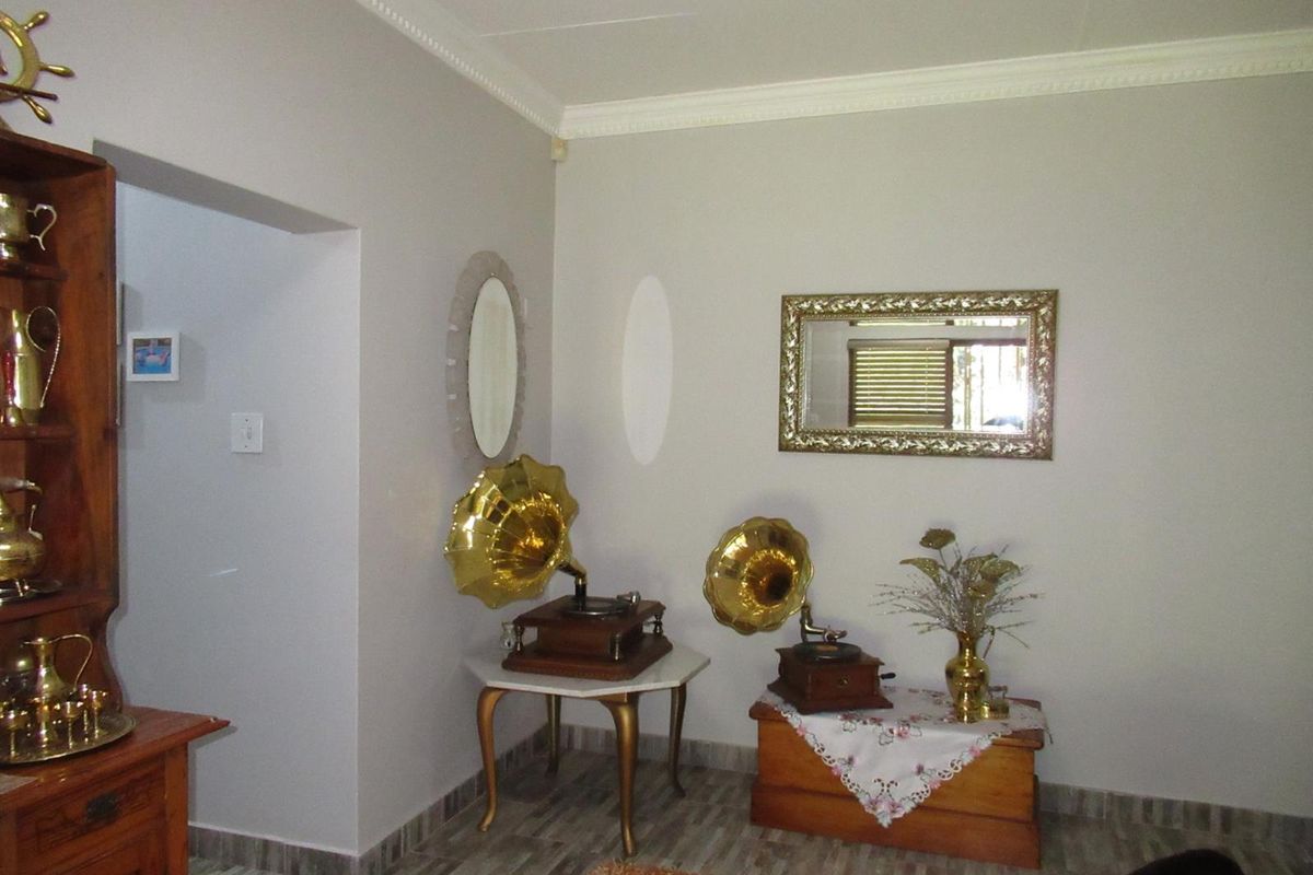 A well-maintained interior living space featuring decorative crown molding and tiled flooring, providing a neutral backdrop for personal decor.