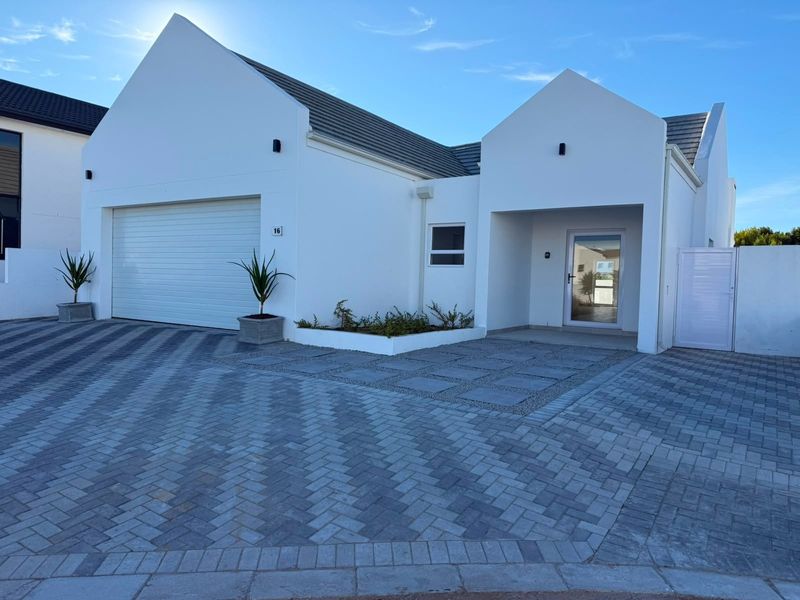 Modern front elevation featuring a clean white facade, double garage, paved driveway, and a welcoming entrance with contemporary architectural lines.