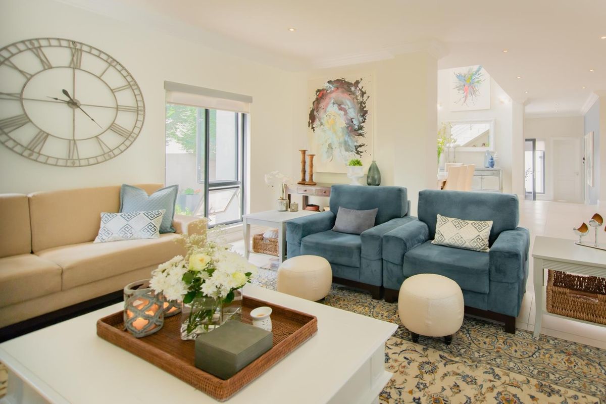 A bright and inviting living room featuring recessed downlighting, neutral wall finishes, and a sliding glass door providing access to the exterior.