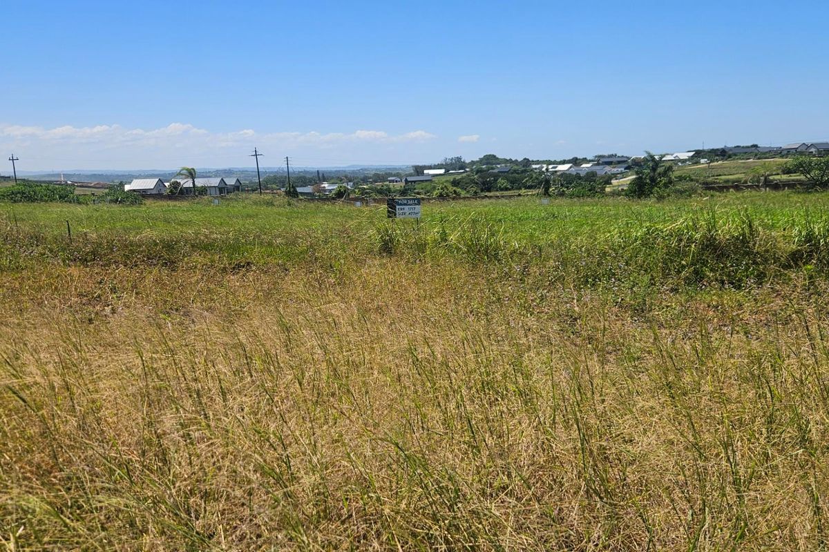A view of a vacant residential plot of land with surrounding neighborhood views.