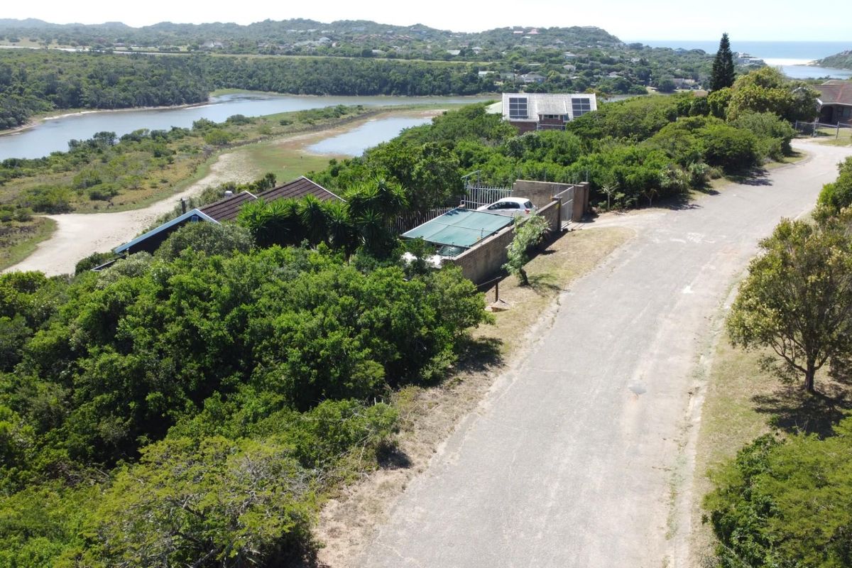 Aerial view of the residential property showing the surrounding landscape, access road, and proximity to the nearby estuary and coastal area.