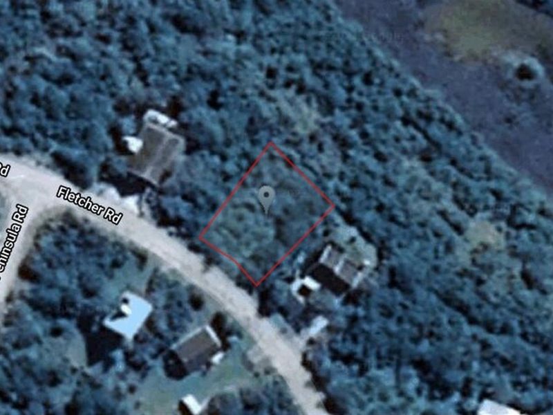 Aerial view of a vacant residential plot located near Fletcher Road, showing surrounding vegetation and local street access.