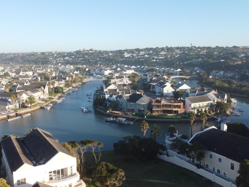 An elevated aerial view of a residential estate featuring waterfront properties along a canal system.