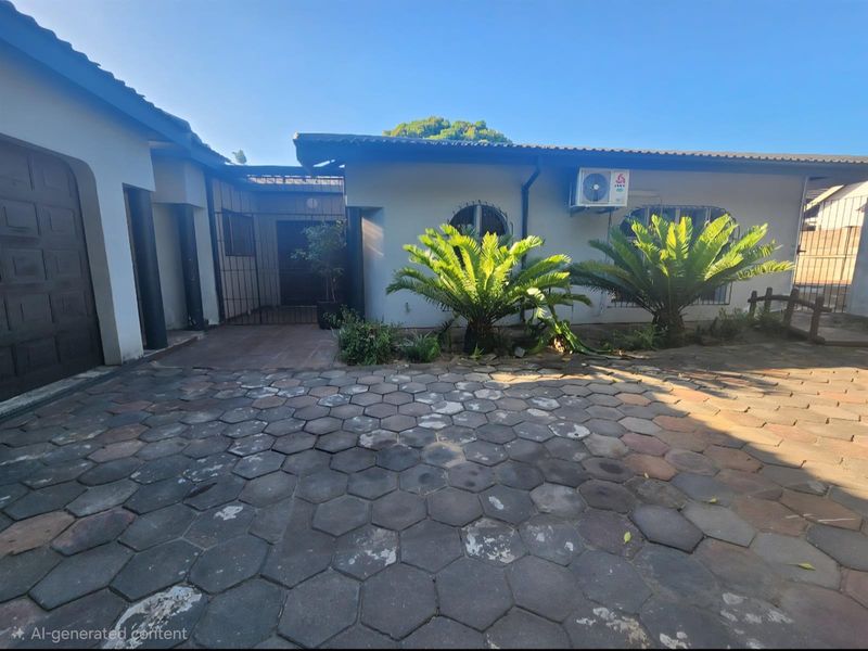 Front exterior view of the property featuring a paved driveway, security gates, and an installed air conditioning unit.
