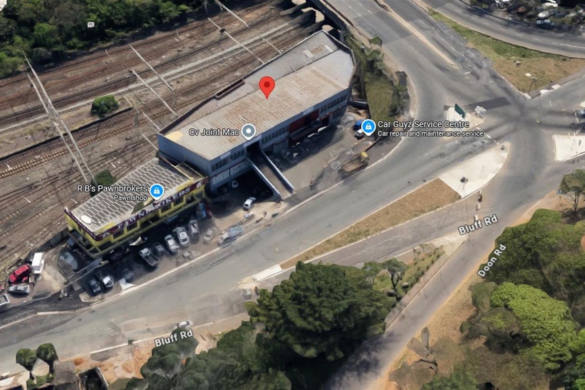 Aerial view of an industrial property complex located at the intersection of Bluff Road and Doon Road, featuring multiple commercial units and adjacent railway lines.