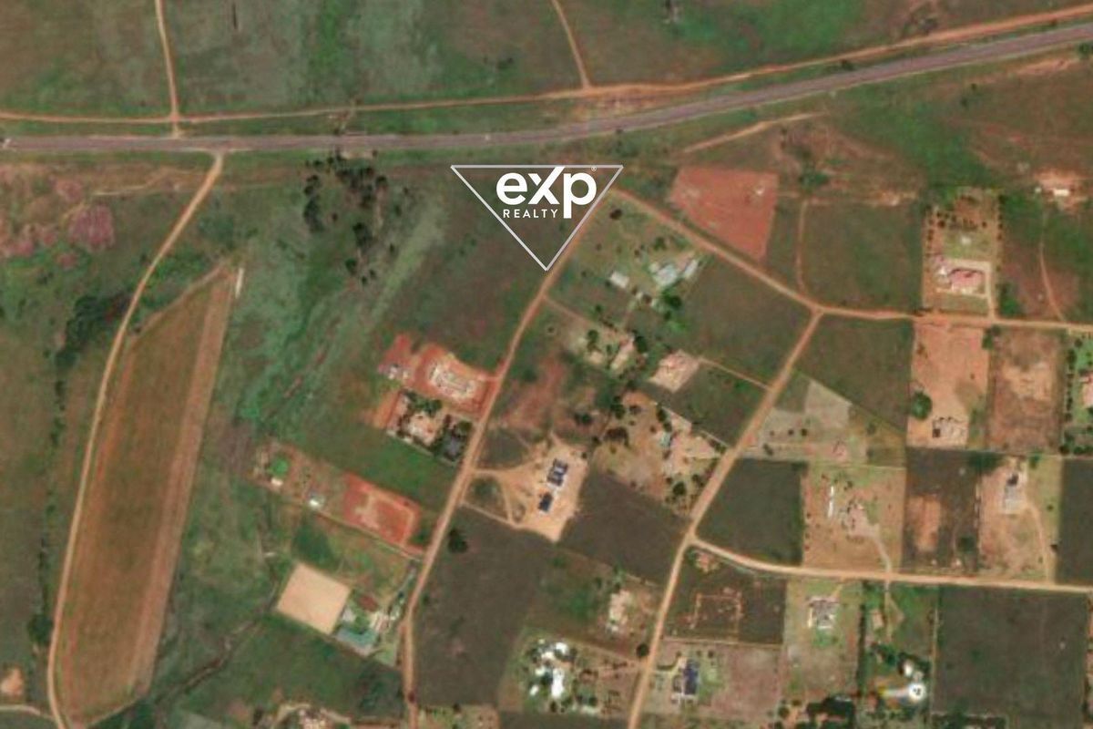 An aerial view of the residential land area showing surrounding plots, road access, and local landscape features.