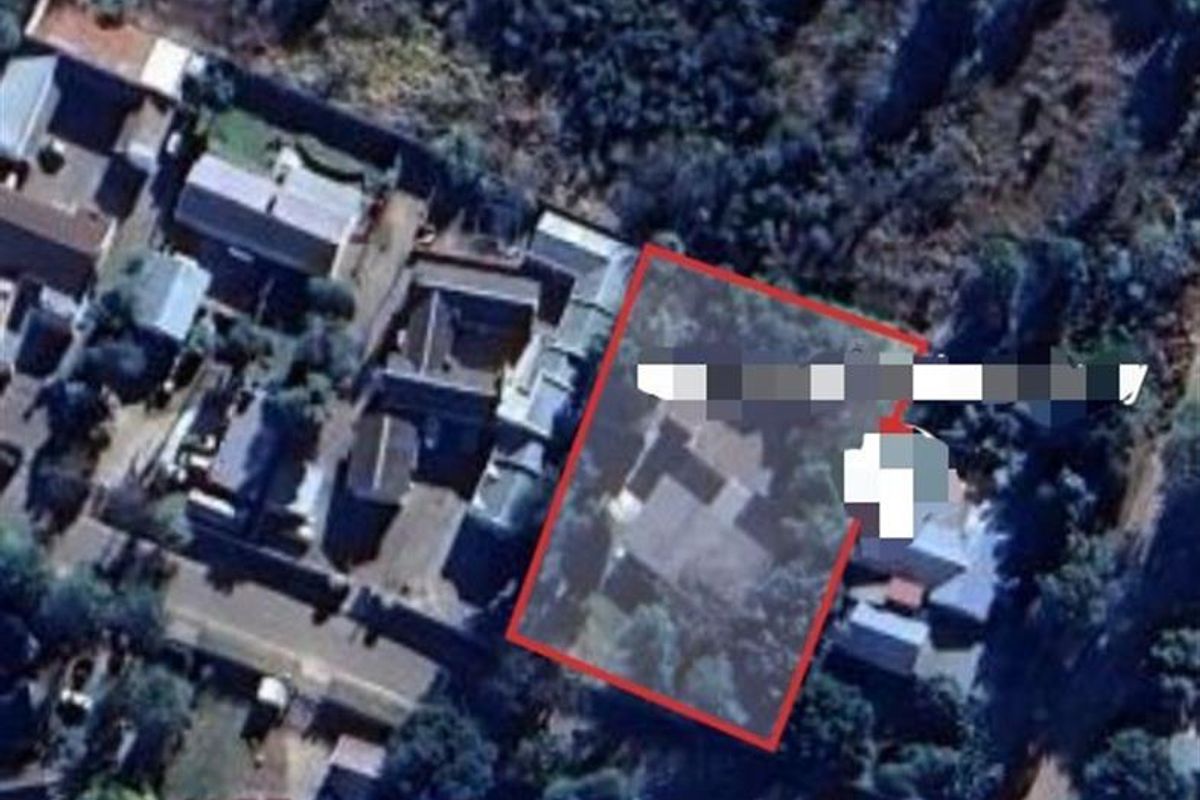 An aerial view of the property highlighting the plot boundaries and surrounding residential area.