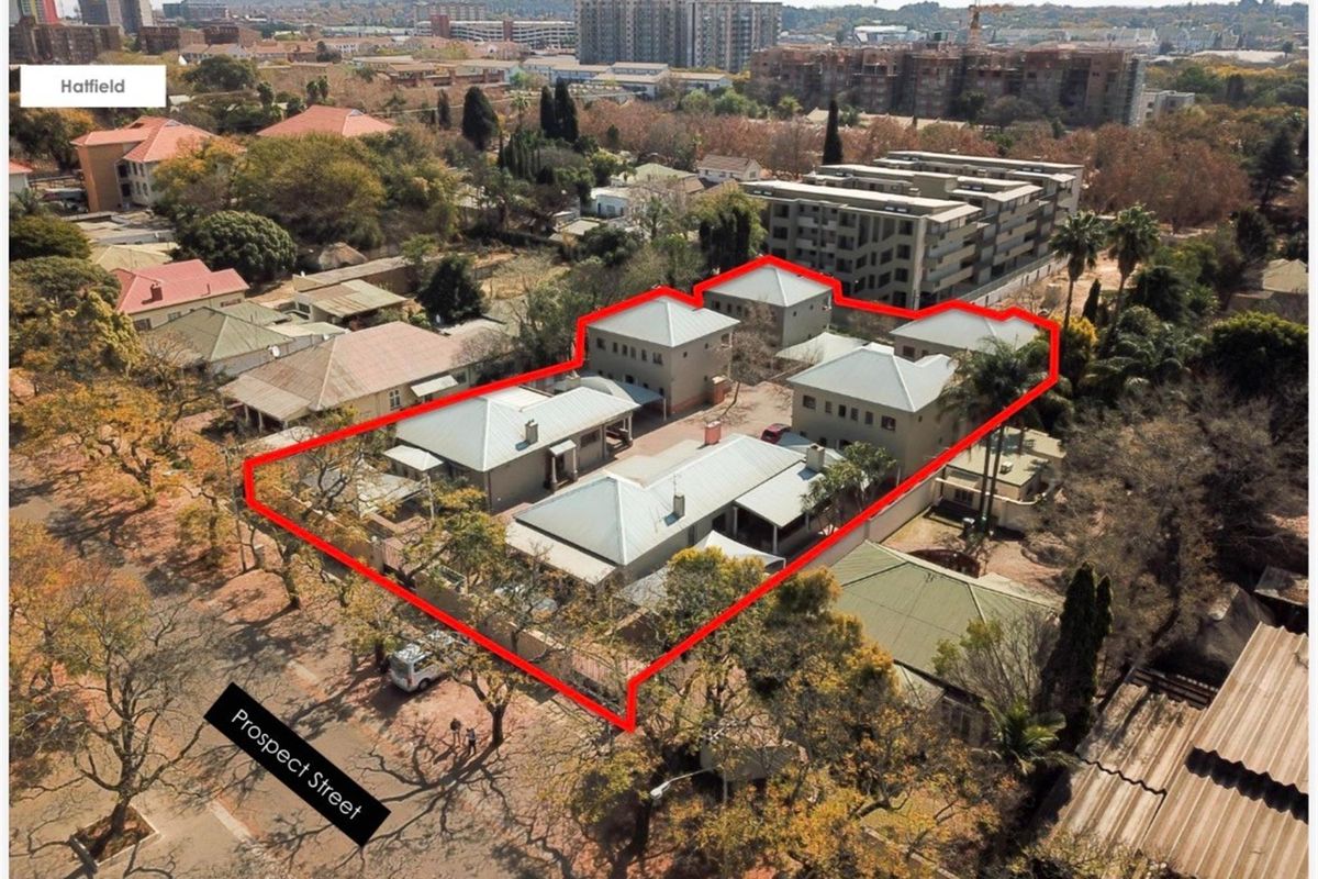 Aerial view of a commercial property complex in Hatfield, featuring multiple buildings with pitched roofs and paved access areas.
