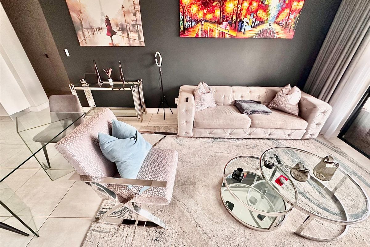 A modern living room featuring tiled flooring and a neutral color palette, creating a comfortable and well-maintained space.
