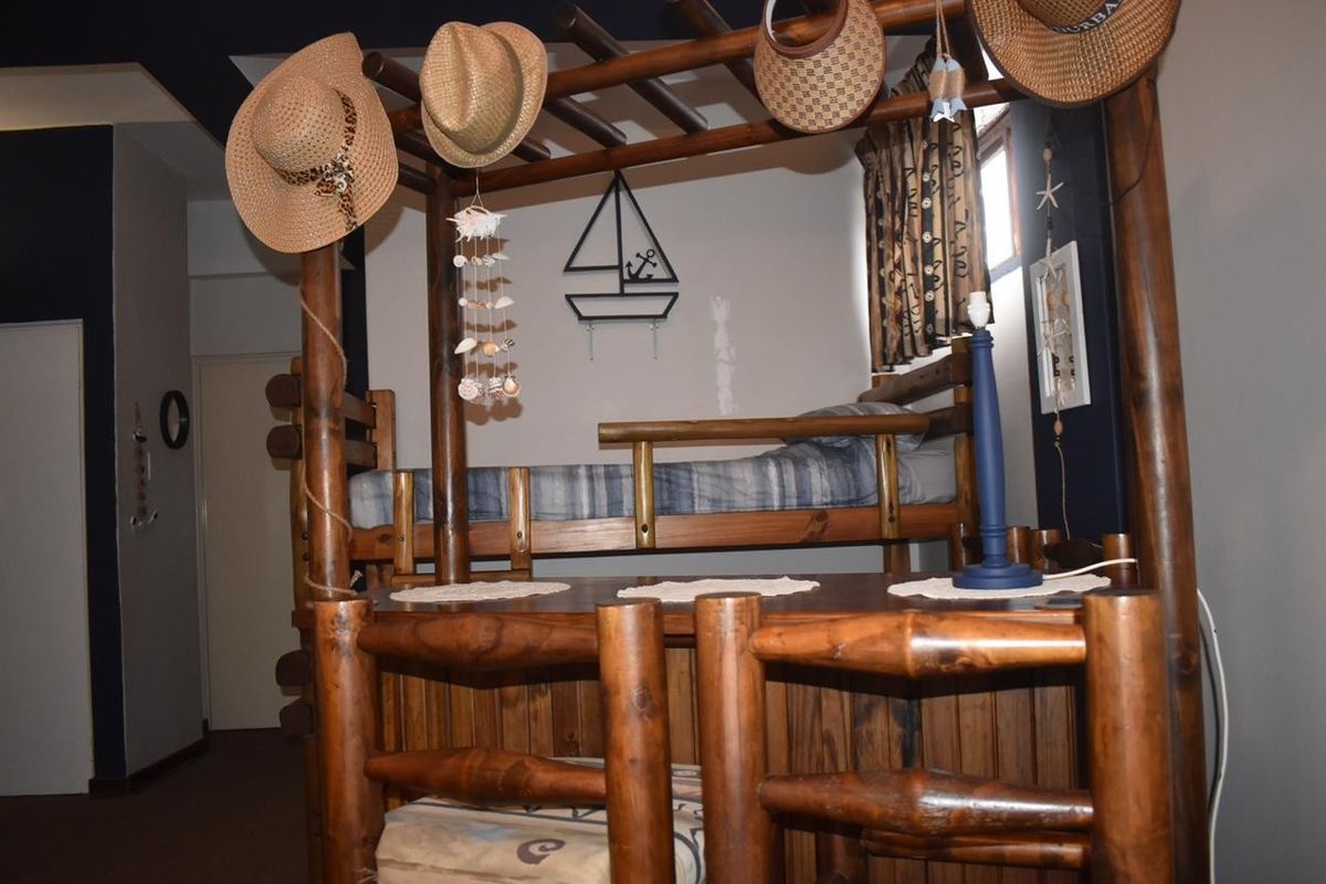 A bedroom featuring a custom built-in wooden bunk bed structure with integrated desk space.