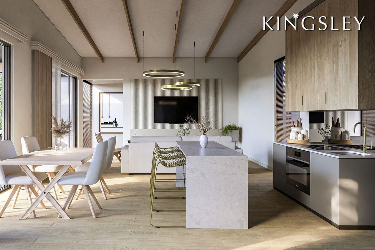 Modern open-plan living area featuring a sleek kitchen with stone island, timber cabinetry, exposed ceiling beams, and a contemporary slatted feature wall.