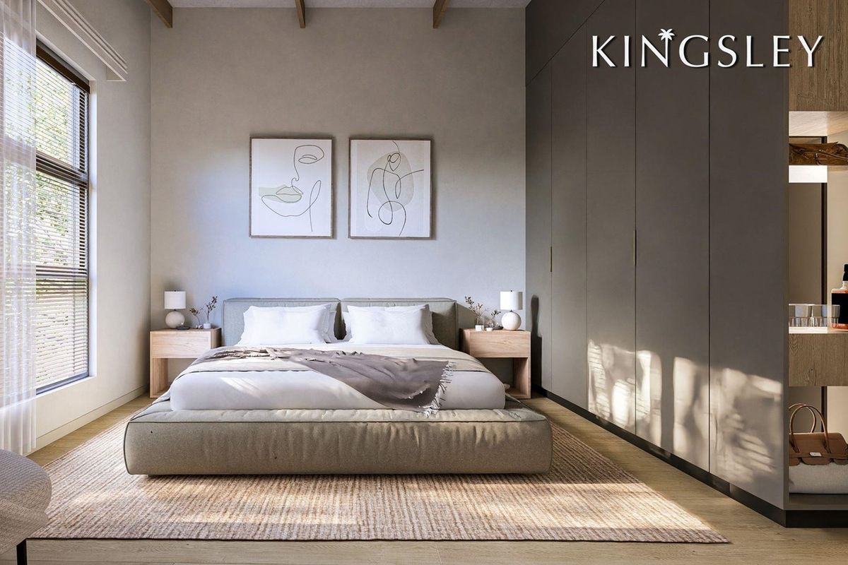 Modern bedroom featuring high ceilings with exposed timber beams, sleek floor-to-ceiling built-in cupboards, and warm timber flooring.