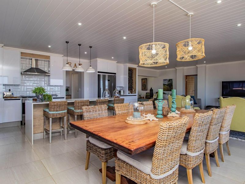 Spacious open-plan living area featuring a modern kitchen with breakfast bar, dining space, and contemporary finishes throughout.